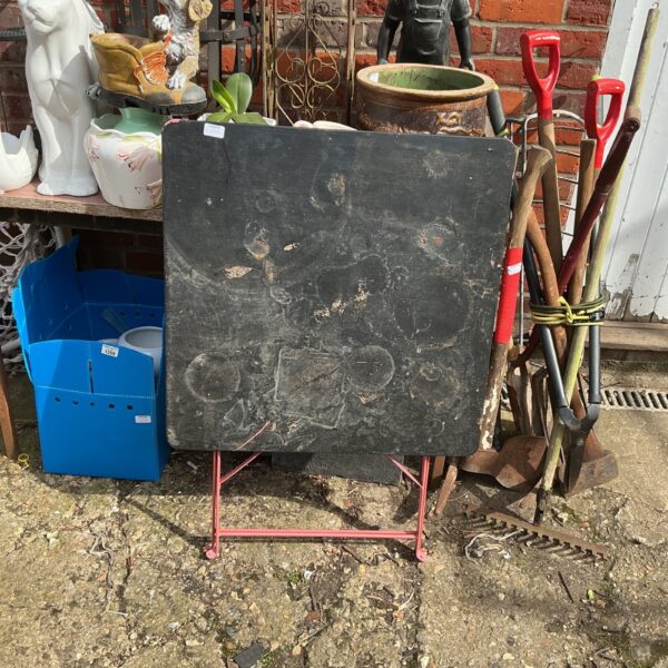 Vintage folding potting table in a garden setting.