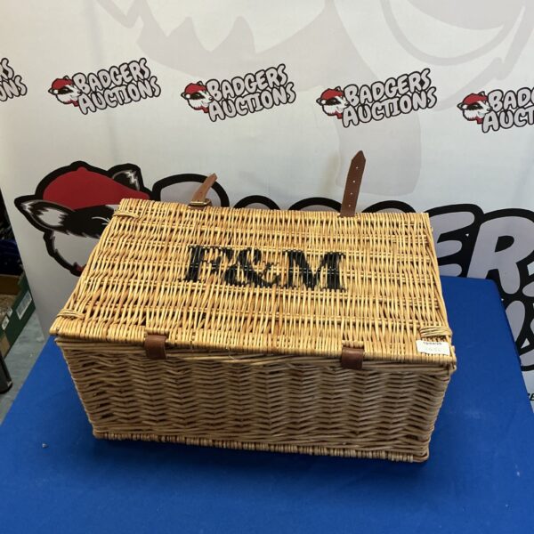 Classic Fortnum and Mason wicker picnic basket with handles.