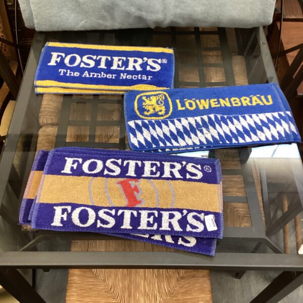 Vintage beer mats from Fosters and Lowenbrau, collectible pub memorabilia.
