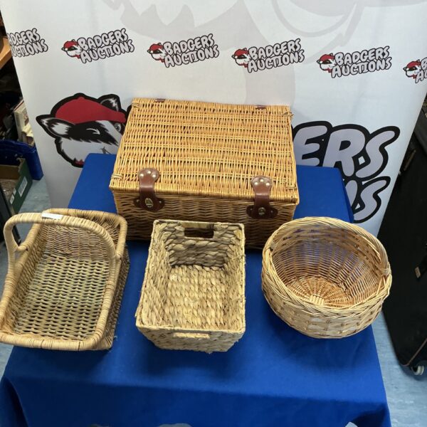 Four vintage wicker baskets for storage and display.