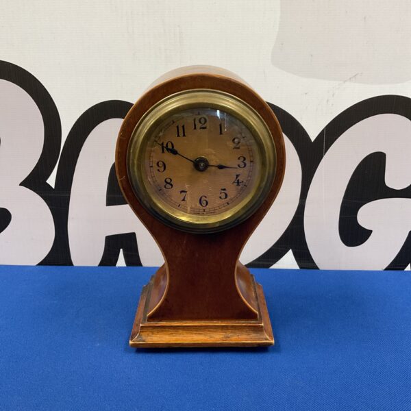 Antique French balloon clock with mahogany case and white dial.