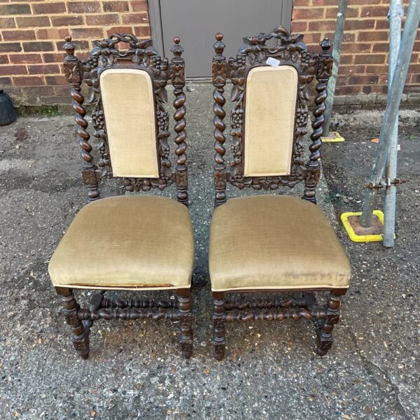 Ornate pair of 19th-century French Neo-Renaissance carved oak chairs.