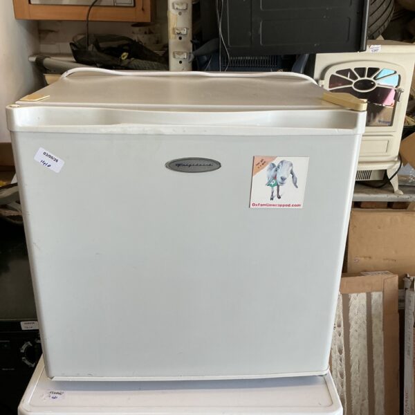 Vintage Frigidaire countertop fridge in used condition.