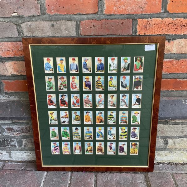 Framed display of vintage Gallagher Ltd jockey cards, a colourful horse racing collectible.