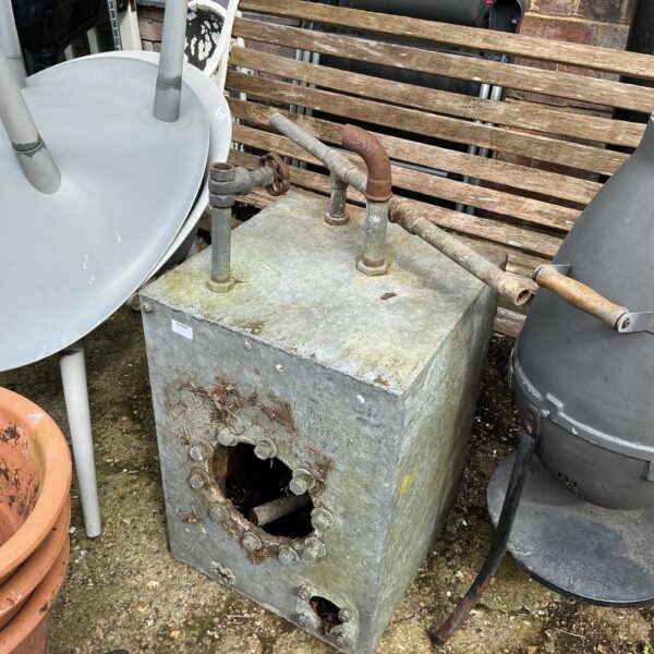 Vintage galvanised water tank, showing signs of weathering and age.