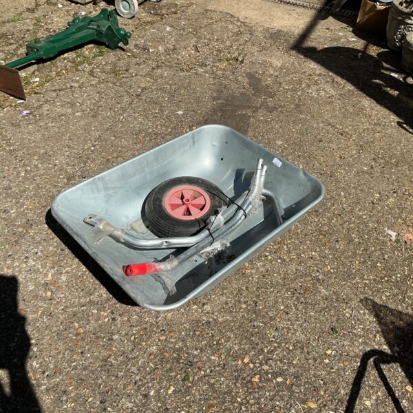 Galvanised wheelbarrow kit in disassembled form, ready for restoration.