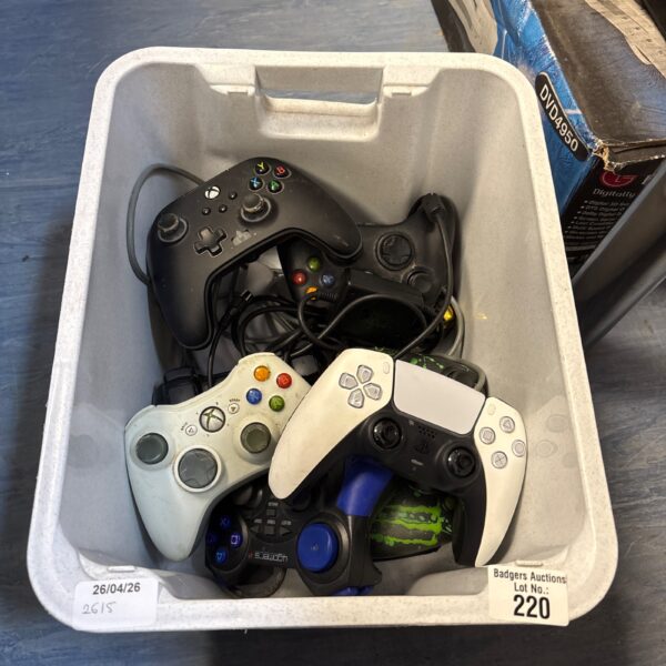 Mixed lot of Xbox and PlayStation gaming controllers for retro gaming.