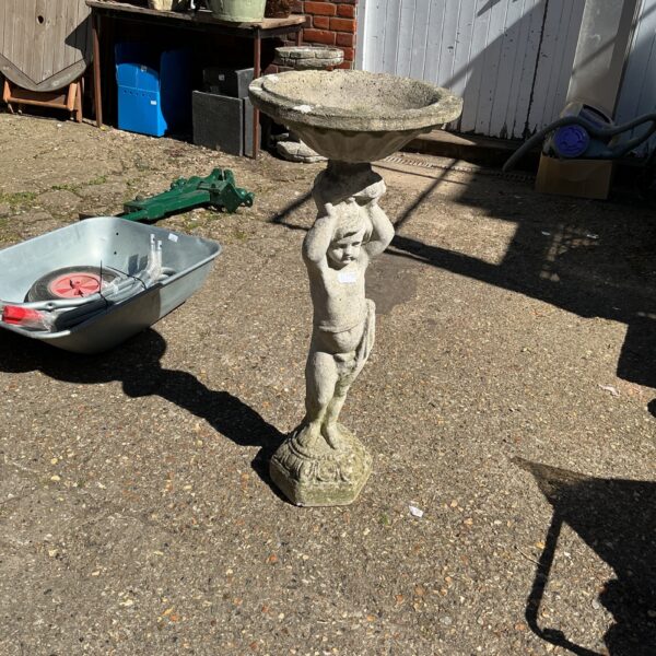 Cherub garden birdbath with tiered bowl for attracting birds.
