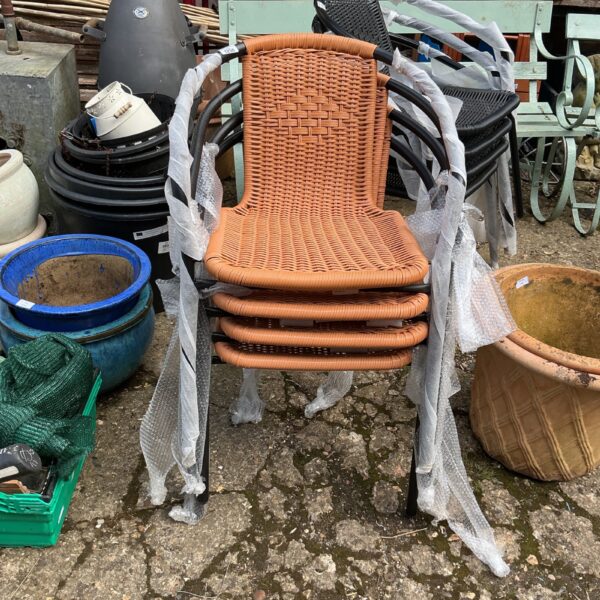 Four new garden chairs with woven seats and black frames.