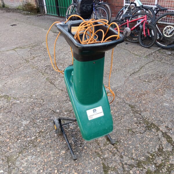 Side view of a used garden chipper shredder with orange cable.