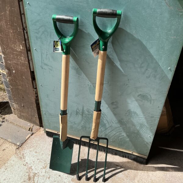Used garden fork and spade set with wooden handles.
