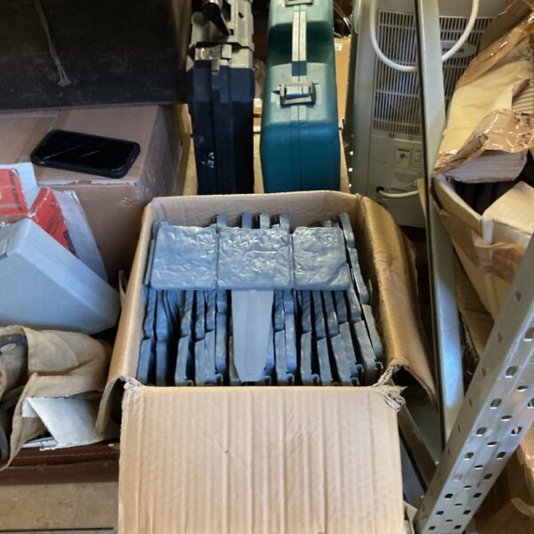 Stack of plastic garden landscape edging panels in a cardboard box.
