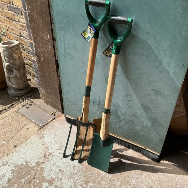 Vintage garden spade and fork set with wooden handles.