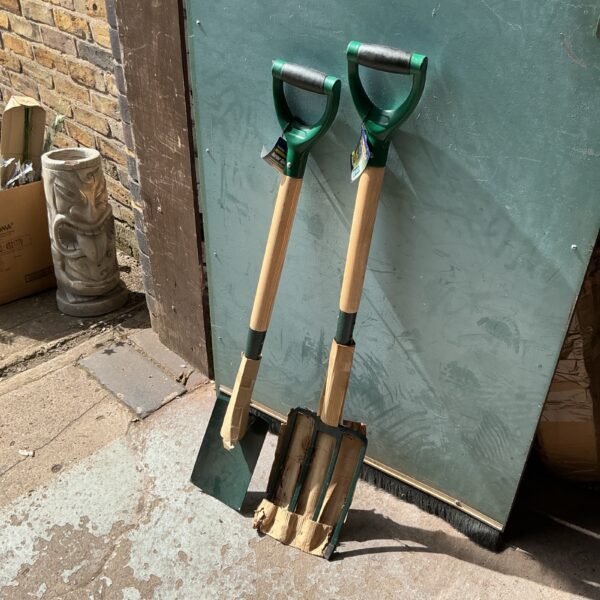 Vintage garden spade and fork set with wooden handles.