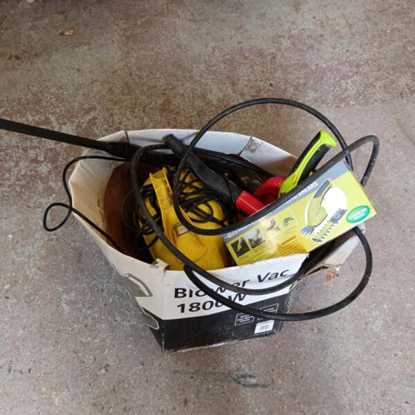Garden tool lot with electric pruner and pressure washer parts.