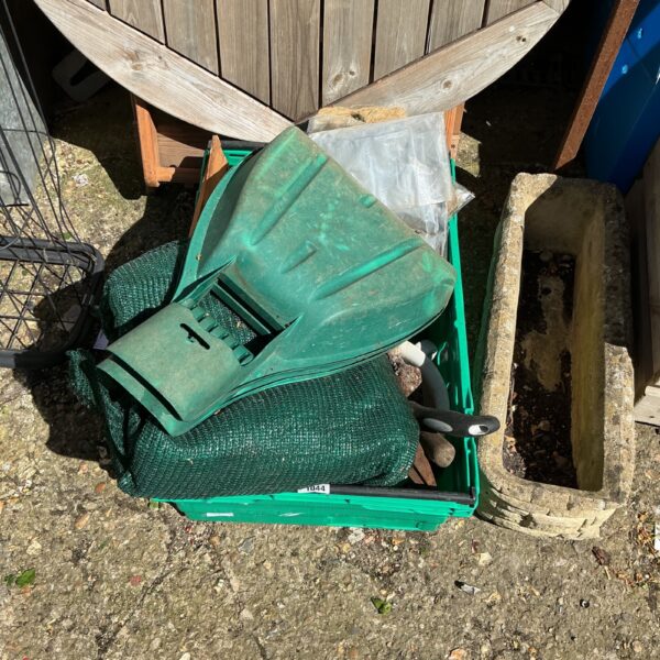 Assorted garden tools in a plastic tray, ready for use.