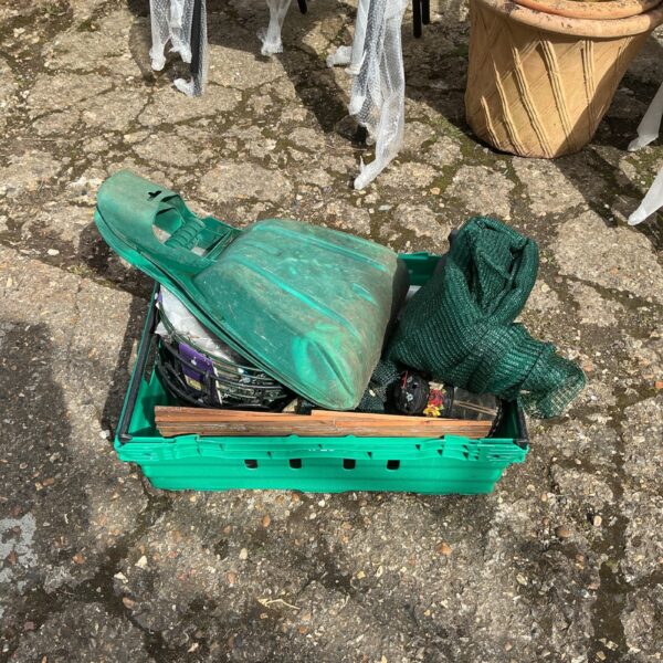 Tray of assorted garden tools including leaf lifters for garden maintenance.