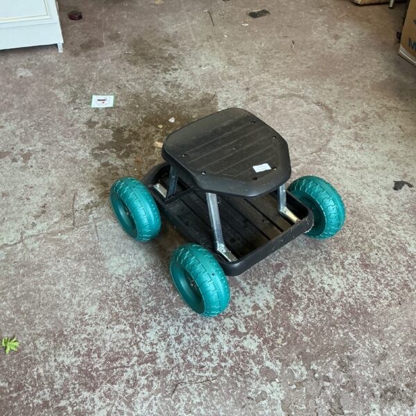 Side view of a gardening weeding trolley with pneumatic tyres.