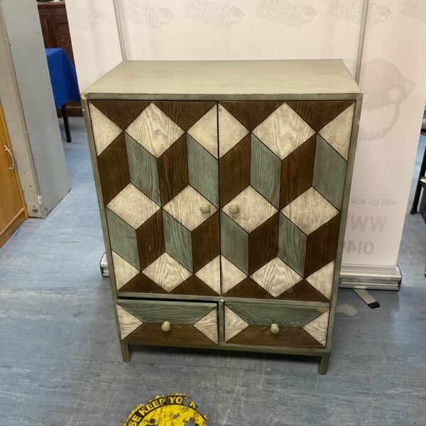 Colourful geometric painted wooden cabinet for storage.