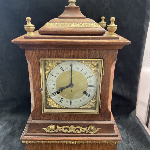 Antique German oak bracket clock with brass dial.