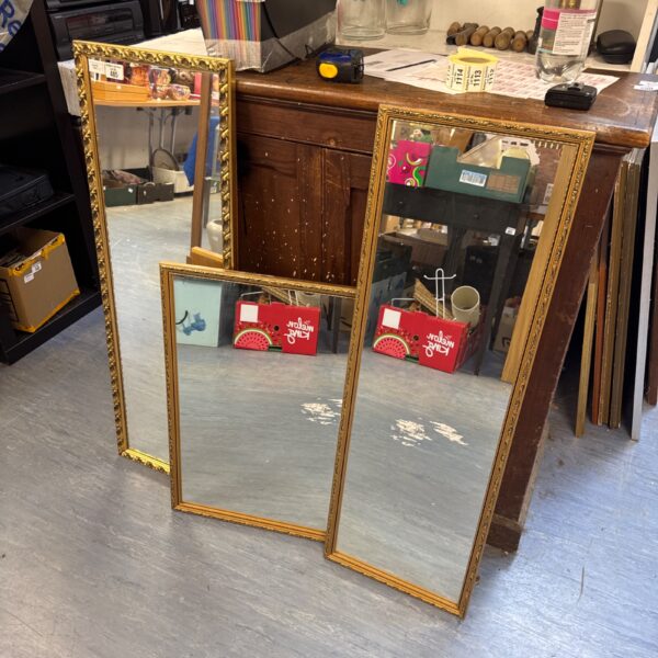 Vintage gilt framed mirror with a gold frame for wall decor.