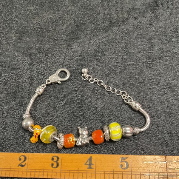 Colourful glass bead charm bracelet on a snake chain.