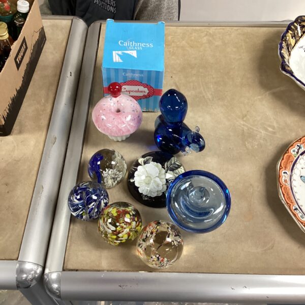 Colourful glass paperweights including a Caithness example, collectible art glass.