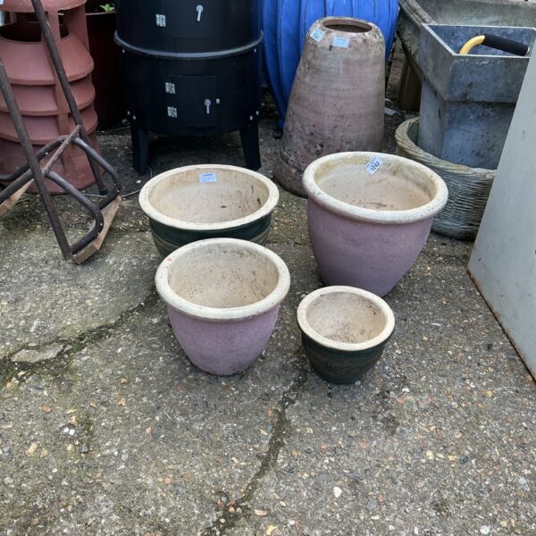 Lot of four vibrant glazed terracotta garden pots.