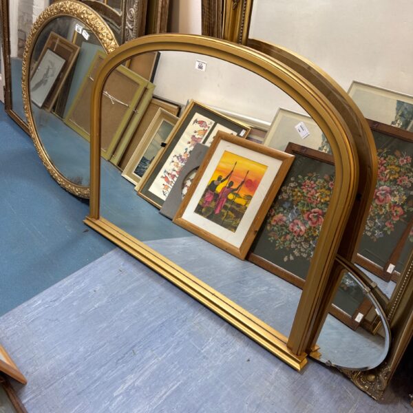 Large antique gold overmantle mirror with ornate frame.