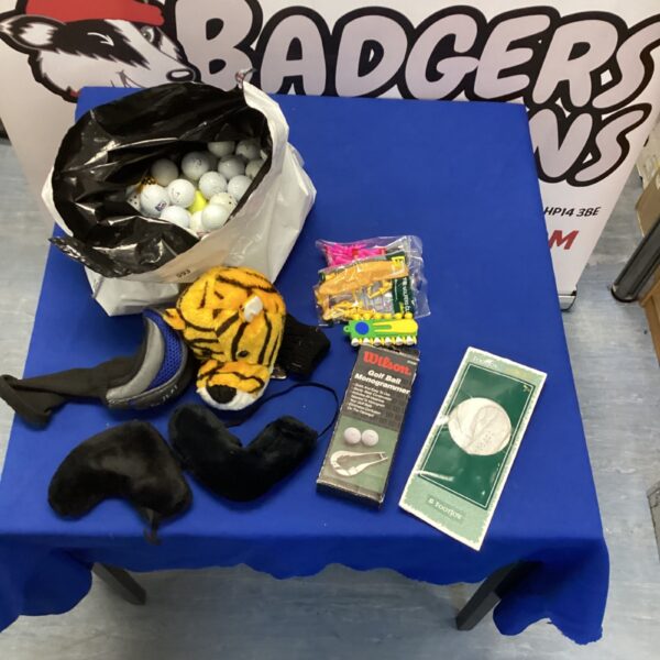 Golf balls and accessories lot including Wilson monogram and club socks.