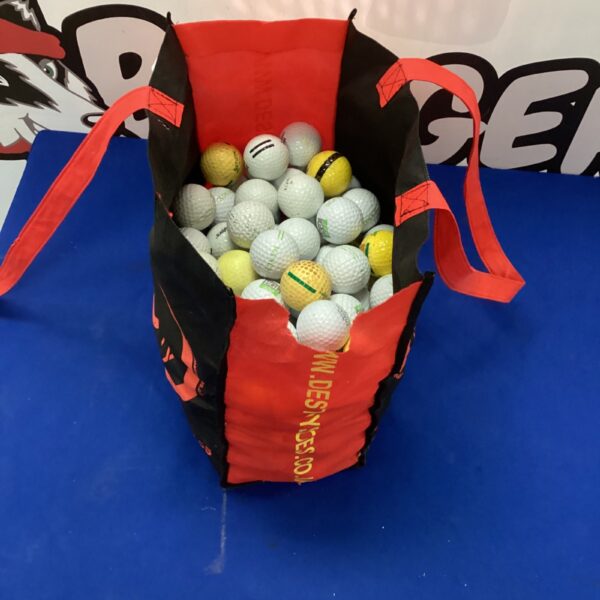 Red bag filled with a lot of used golf balls for practice.