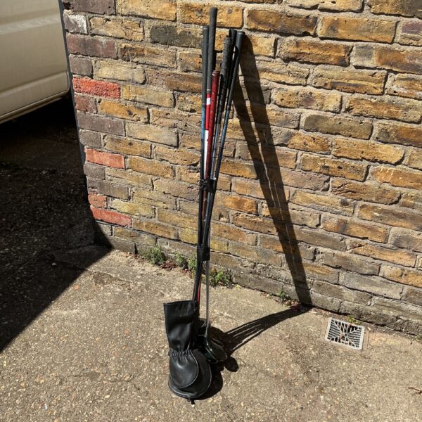Golf club collection featuring a driver and head cover.