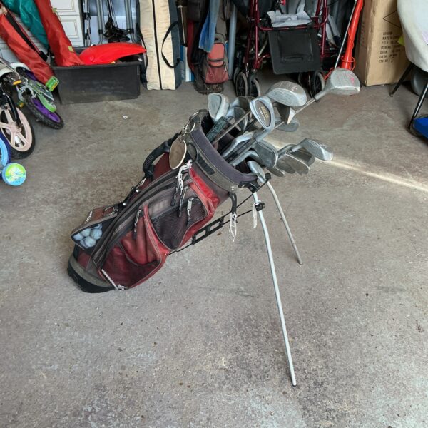 Black and red golf club set with carrying bag.