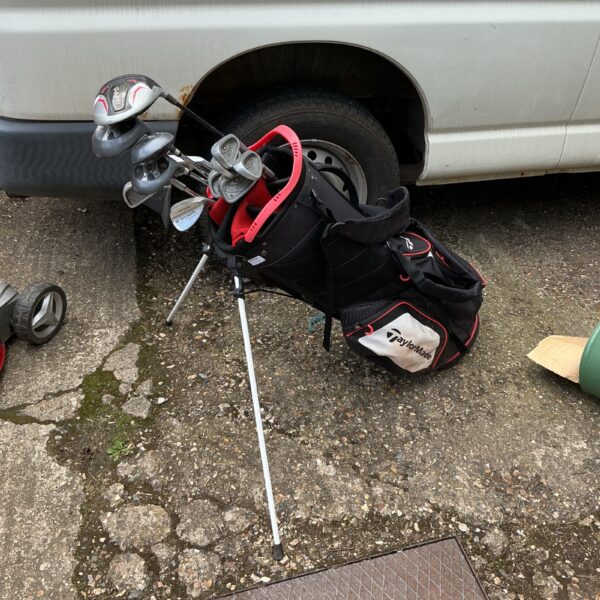 TaylorMade golf clubs and bag set showing signs of use.