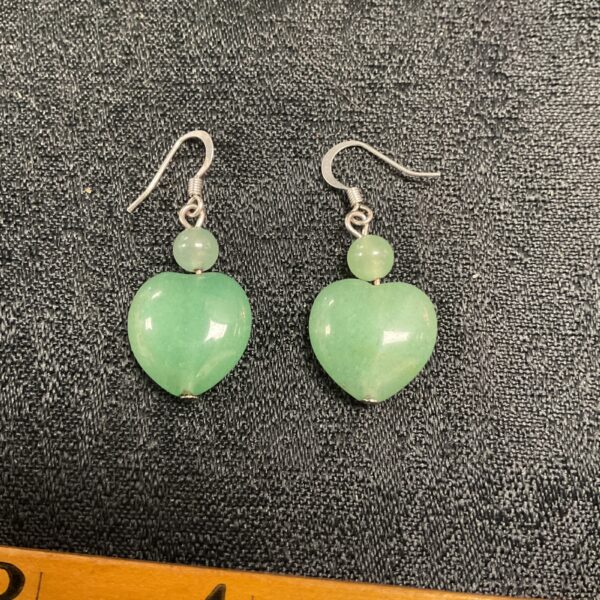 Close-up of green jade heart earrings, delicate and elegant.