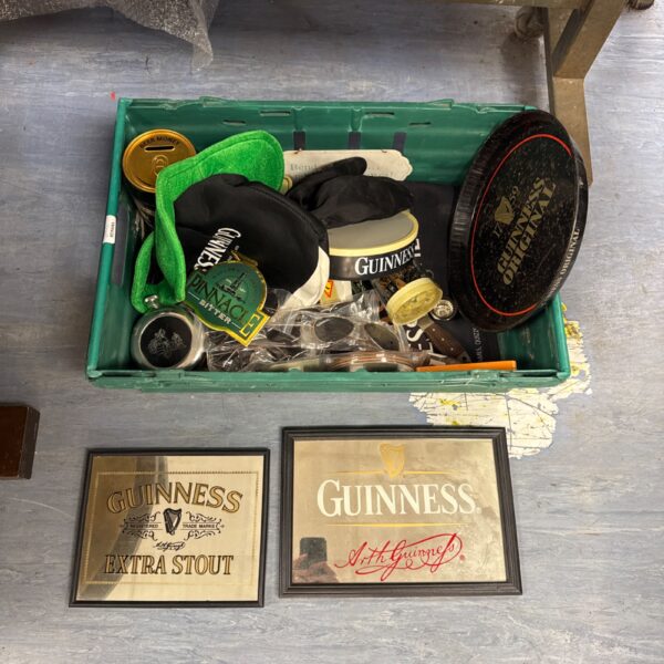 Vintage Guinness memorabilia lot with mirrors, tray and sunglasses.