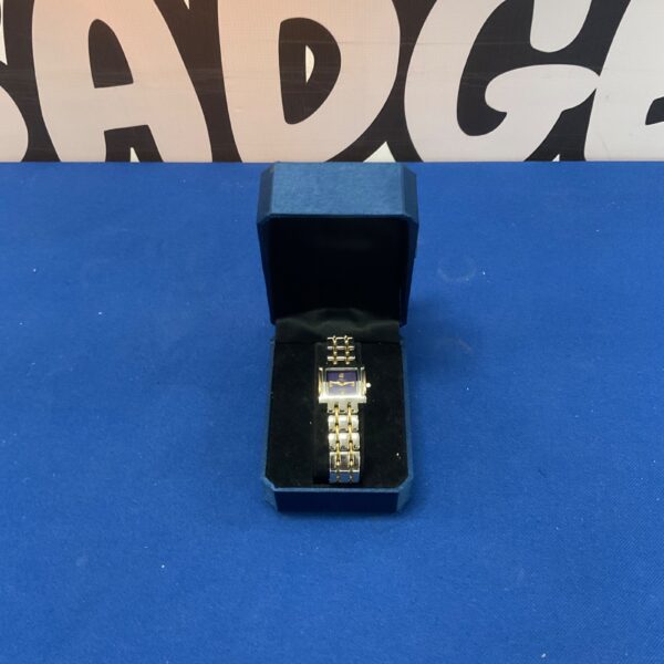 Gold-tone Guy de Vintal wristwatch on display.