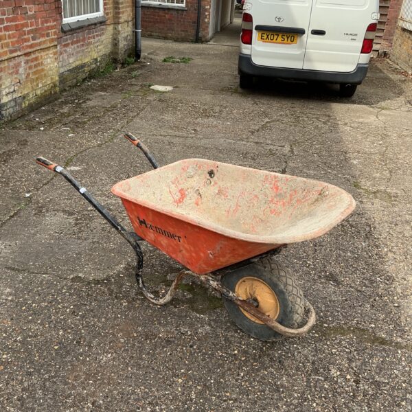 Used Haemmer wheelbarrow in a garden setting.