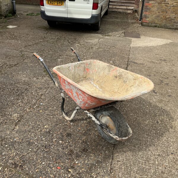 Used Haemmer wheelbarrow in a garden setting.