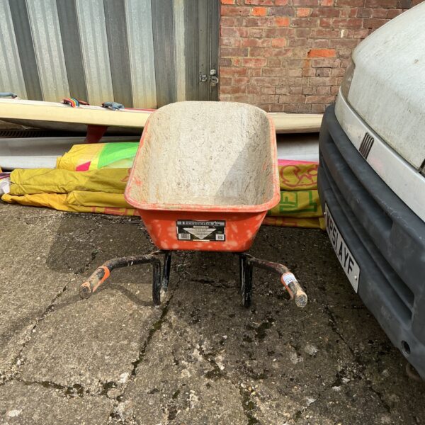 Used Haemmer wheelbarrow in a garden setting.