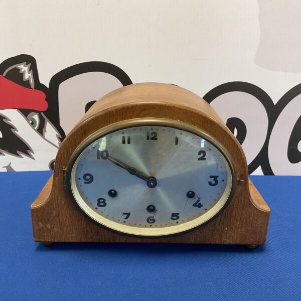 Vintage Haller mantle clock with blue face and wooden case.