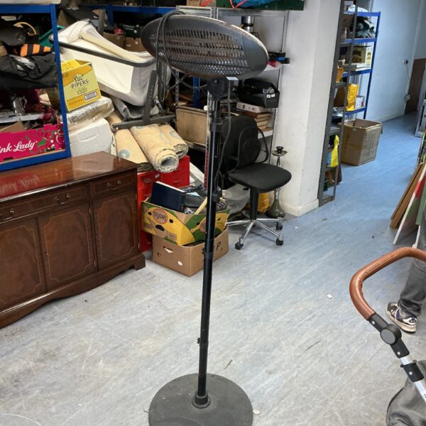 Used halogen patio heater in a garden setting.