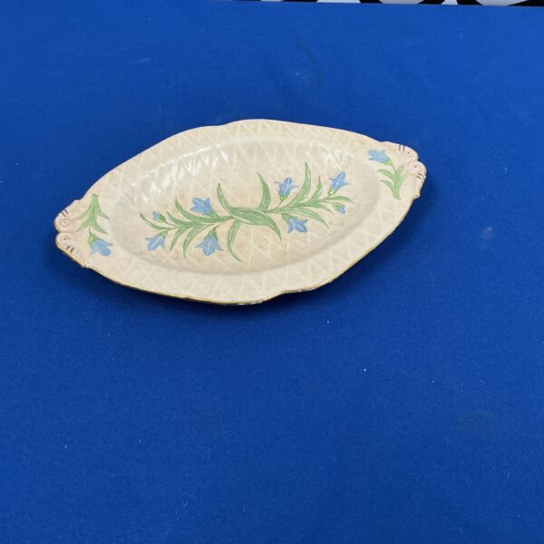 Vintage hand-painted porcelain dish with floral design.