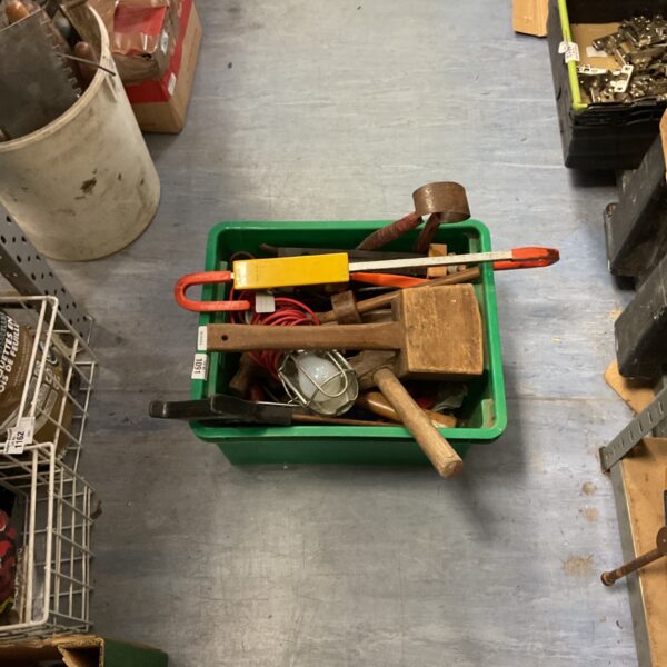 Crate filled with a collection of vintage hand tools and saws.