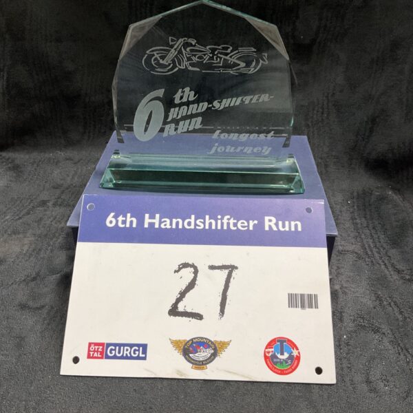 Vintage handshifter glass trophy with motorcycle design.