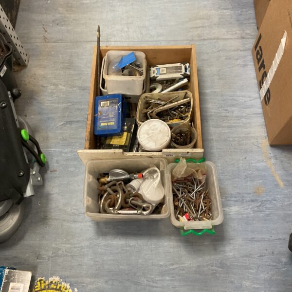 Mixed hardware assortment including nails, screws, and wrenches.