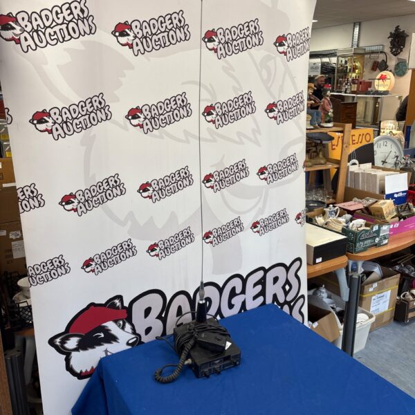 Vintage Harrier CB radio displayed in front of a branded backdrop.
