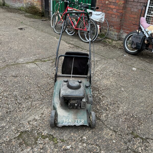 Vintage Hayter lawnmower in a garden setting.