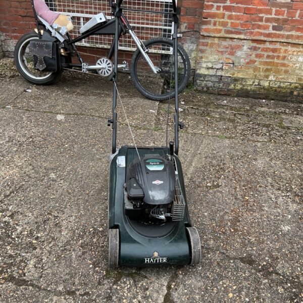 Vintage Hayter Sprint lawnmower in a garden setting.