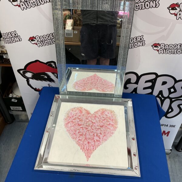 Silver heart-shaped wall mirror for bedroom or living room decor.